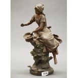 A French spelter figure of a girl entitled 'Fermiere', H. 39cm.