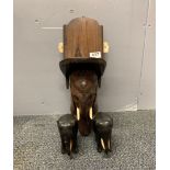 An unusual carved elephant head wall bracket, H. 44cm, and two ebony elephants.