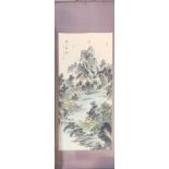 A Chinese silk mounted printed scroll of a mountain landscape, 69 x 180cm.