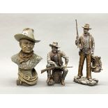 A group of three cold cast figures of John Wayne, tallest H. 36cm (one gun slightly A/F).