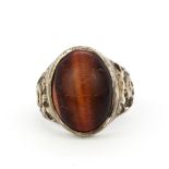 A heavy gent's silver ring set with a large cabochon oval tigers eye, (T.5).
