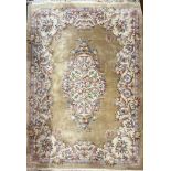 A large Chinese gold ground washed wool carpet, W. 273cm.