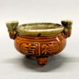 A Chinese Ming dynasty style glazed pottery oil lamp, W. 15cm.