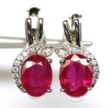 A pair of 925 silver earrings set with oval cut ruby and white stones, L. 1.5cm.