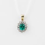 A 9ct yellow gold (tested) pendant set with a green stone surrounded by diamonds, L. 1.6cm.