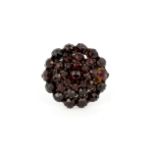 A yellow metal large cluster ring set with rose cut garnets, (S.5).