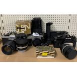 A group of Nikon cameras, camera body's and lenses.