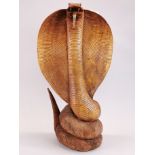 A large Indian carved hardwood figure of a cobra, H. 61cm.