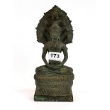 A Siamese bronze figure of a seated Buddha, surmounted by seven Naga, H. 24cm.