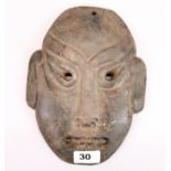 An interesting Chinese black jade / hardstone archaic form monkey mask, H. 24cm.