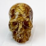 A hand carved amber skull, originally from Indonesia, and dating back to the Miocene (approx. 23