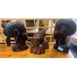 A pair of African carved hardwood wall busts and a pair of carved busts.