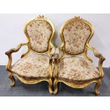 A pair of impressive upholstered gilt wood armchairs.