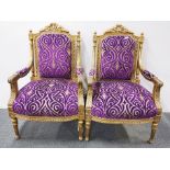 A pair of upholstered gilt wood armchairs..