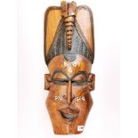 An inlaid African hardwood tribal mask, H. 60cm.