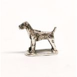 A miniature sterling silver terrier dog, H. 1.5cm.