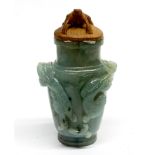 A Chinese carved jade bottle decorated in relief with three young dragons, with carved wooden lid,