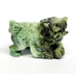 An impressive Chinese carved jade lion dog figure, 9 x 5 x 7cm.
