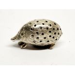 A small white metal (tested silver) hedgehog pin cushion, L. 5cm.