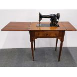 A mahogany cased sewing machine 64 x 65 x 79cm.