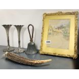 A framed Edwardian watercolour, with an antique bell, a pair of epergne vases, and an antler cigar