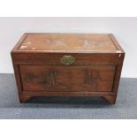 An impressive Oriental carved teak wood and camphor wood lined blanket chest, 103 x 53 x 60cm.
