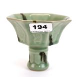 A Chinese green glazed octagonal porcelain stem cup decorated with the eight Lohan, H. 11cm.