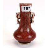 A small Chinese Sang de Boeuf glazed porcelain vase with elephant head handles, H. 15cm.