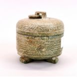 A Chinese carved jade / hardstone box and cover with integral ring handle, H. 10cm, Dia. 10cm.