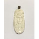 A hand carved buffalo bone pendant with Native American Indian face, eagle and bear and a 925 silver