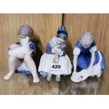 Three Royal Copenhagen figures of children, H. 15cm.