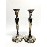 A pair of sterling silver column candlesticks, H. 27cm.