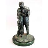 An unusual bronze figure of a couple dancing on a green stone base, H. 52cm.