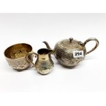 A Victorian British hallmarked Indian hammered silver tea set, teapot L. 20cm.