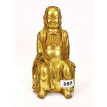 A Tibetan gilt bronze figure of a seated deity, H. 24cm.