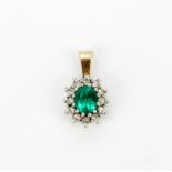 A 9ct yellow gold (tested) pendant set with a green stone surrounded by diamonds, L. 1.6cm.