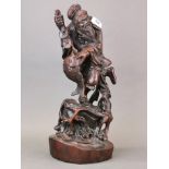 A Chinese carved hardwood figure of a fisherman taking cash from a fish, H. 47cm. Slightly A/F.