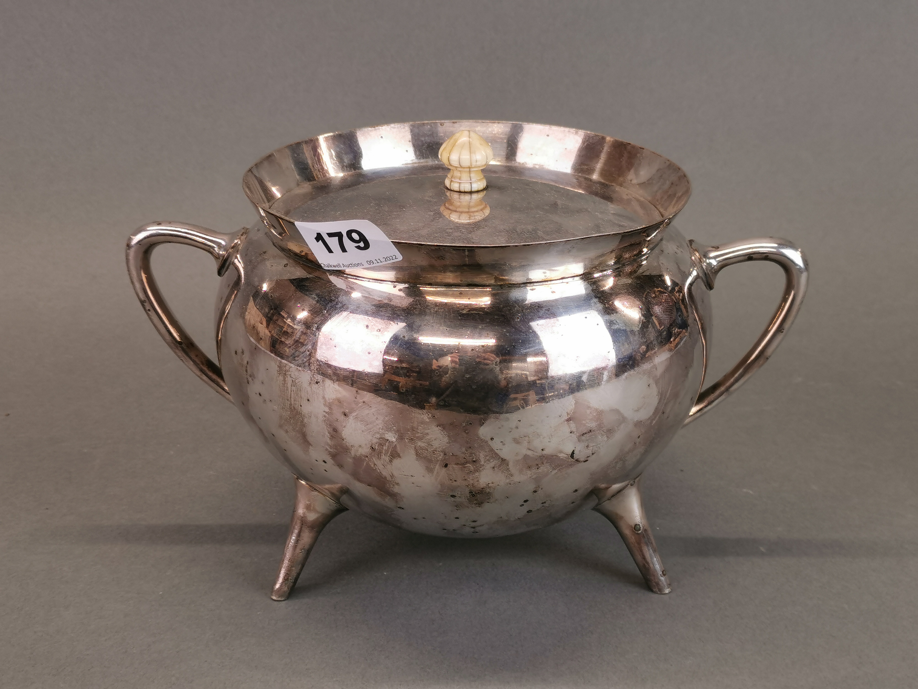 A Christopher Dresser style silver plated cauldron shaped punch bowl and cover, W. 27cm, H. 18cm.