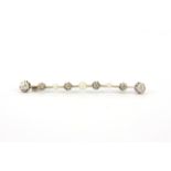 An early 20th century white metal (tested minimum 9ct gold) brooch set with old cut diamonds and