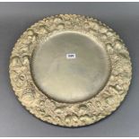 A large hammered white metal fruit decorated tray / charger, decorated with a crown monogram, Dia.