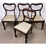 A set of four Regency carved rosewood dining chairs with drop in seats.