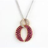 An 18ct yellow gold pendant set with round cut rubies, approx. 1.59ct total, and brilliant cut