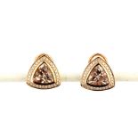 A pair of 18ct (stamped 750) rose gold earrings each set with a large trillion cut morganite