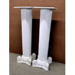 A pair of large painted plaster columns with wooden tops, H. 104cm.