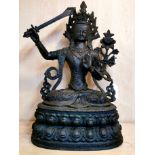 A large Tibetan cast bronze figure of a seated Tara, H. 38cm.