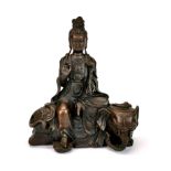 A Chinese bronze figure of Guanyin seated on an elephant, H. 22cm.