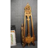 A carved artist's wooden easel, a further easel and a quantity of artwork, H. 172cm.