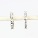 A pair of 18ct white gold hoop earrings set with baguette and round brilliant cut diamonds,