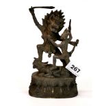 A Tibetan cast bronze figure of a guardian deity, H. 20cm.