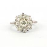 A hallmarked 18ct white gold diamond set cluster ring, approx. 0.75ct total, (L).